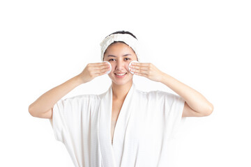 Attractive beautiful natural woman cleaning makeup from her face with cotton pad smile and looking at camera isolated on white background. Skin care and beauty concept.