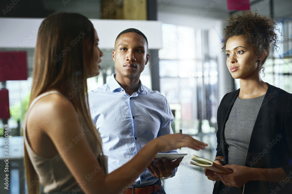 Poster discussions that get things done. shot of a group of young businesspeople having discussion in a mod
