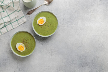 Spinach cream soup with boiled egg top view