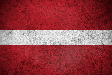 Latvia flag, grunge texture background. National country flag painted on concrete wall