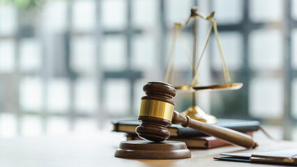 Wooden judges gavel on wooden table, close up.