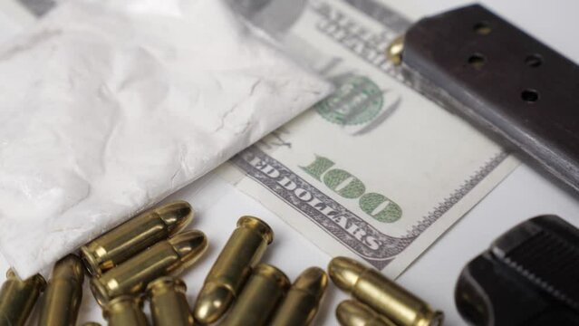 Weapons drugs and dollars. Tilt movement.Outside the law. 