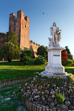 The statue of the painter Giorgione at the medieval walls of Castelfranco Veneto. Treviso province, Veneto, Italy, Europe.