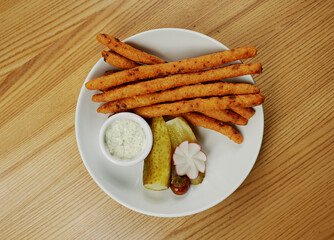 fried cheese sticks with sauce and cucumber