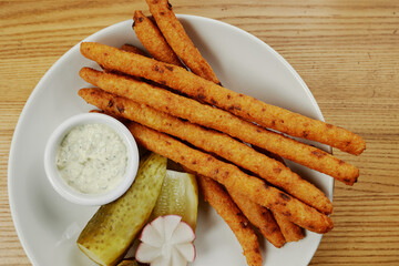 fried cheese sticks with sauce and cucumber