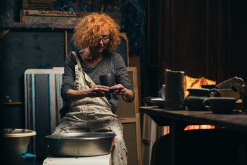 woman are making pottery in her workshop