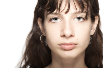 Fototapeta premium Beautiful young girl studio portrait. Looking at camera.