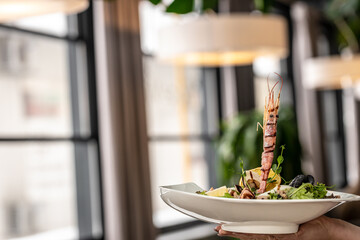 Fresh shrimps salad with lettuce green mix, herbs and olive oil, lemon dressing. healthy food. Restaurant menu, dieting, cookbook recipe top view.