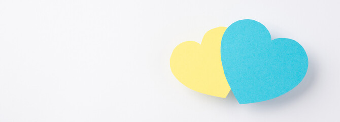 Stop the war in Ukraine concept. Top view photo of national flag colors two yellow and blue hearts on isolated white background with copyspace