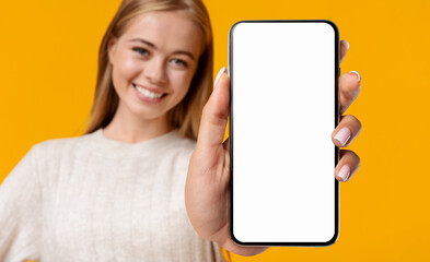 Beautiful Smiling Teenage Girl Demonstrating Smartphone With Blank White Screen