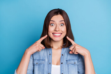 Photo of impressed funny woman wear jeans shirt pointing fingers teeth isolated blue color background - obrazy, fototapety, plakaty