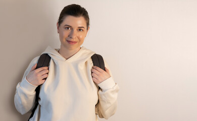 Student woman oversized sweatshirt isolated on wall background with copy space for your design