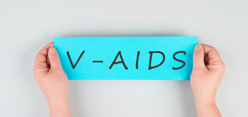 The word v-aids is standing on a paper, new autoimmune disease caused by covid-19 vaccination,...