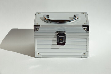 a gray metal suitcase with a handle for jewelry and cosmetics.