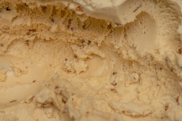 Texture surface of vanilla ice cream with nut. Background of  ice cream close up.