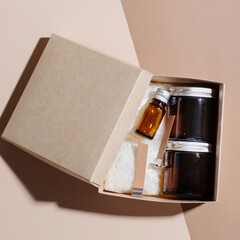 Soy candle making kit. Jar, wax, wick, aroma oil in a box, top view. DIY candle kit