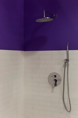Shower cabin with faucet and shower. Design project with white and purple tiles on the walls. Vertical.