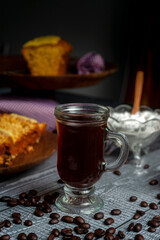 fresh coffee beans with coffee cup, classic metal coffee pot with homemade pudding on wooden plate for breakfast or snack