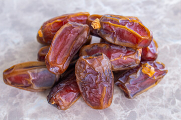 Stack of date fruits on marble background