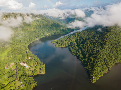 Lake flowing through hilly shores covered with forest
