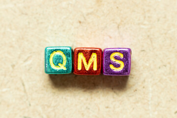 Metallic color alphabet letter block in word QMS (abbreviation of quality management system) on...