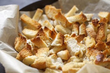 Crackers, baked dry pieces of white bread, in bulk, selective focus.