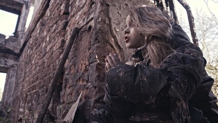 girl praying. Children without a home, apocalypse, war