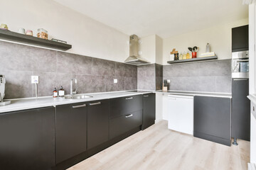 Spacious kitchen with dark furniture