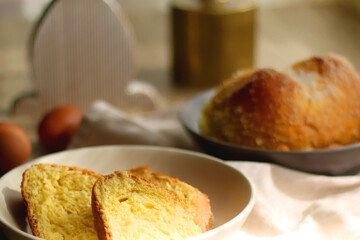 Plate of traditional sweet bread, eaten at Easter time in Croatia. Easter bunny, eggs and flowers on the table. Selective focus.