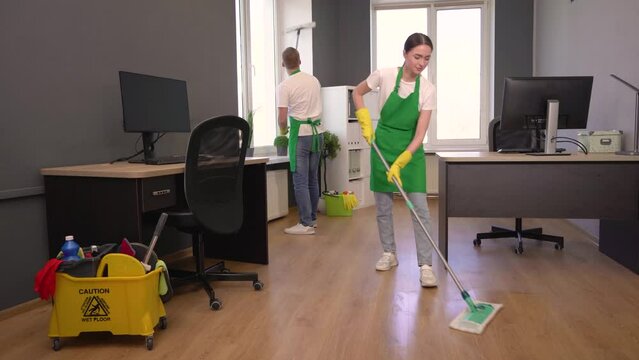 Two janitors working in office. Cleaning service