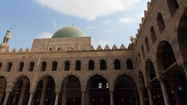 Courtyard of Sultan al-Nasir Muhammad ibn Qalawun mosque with green dome, Cairo in Egypt. Low angle and panning
