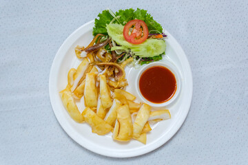 Grilled squid on a white plate with chili sauce It's the best food.