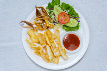 Grilled squid on a white plate with chili sauce It's the best food.