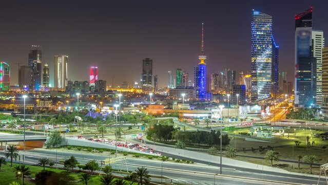 Skyline with Skyscrapers day to night timelapse in Kuwait City downtown illuminated at dusk. Kuwait City, Middle East