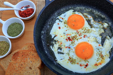 A composition with Fried Egg, Mint, Thyme, Chili pepper and toasts.