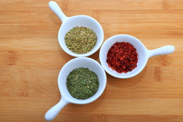 Spices in tiny bowls. Mint, Cayenne Pepper and Thyme.