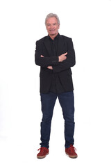 front view of man dressed in jeans sneakers and blazer with arms crossed on white background
