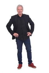 Fototapeta premium front view of man dressed in jeans sneakers and blazer with hands on hip on white background