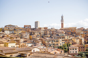 Cityscape of Siena town with bell tower of town hall in Tuscany region of Italy. Concept of visiting italian landmarks