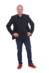 Fototapeta premium front view of man dressed in jeans sneakers and blazer with hands on hip on white background