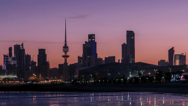 Seaside skyline of Kuwait city from night to day timelapse