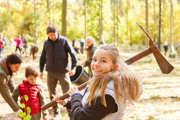 Child with adze ax when planting trees as afforestation