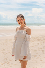 Fototapeta na wymiar Young asian woman in dress enjoying on the beach in summer vacation