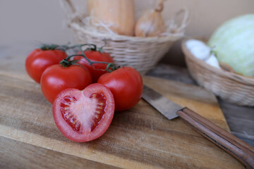 vegetable stocks are laid out on wooden shelf, ripe red tomatoes, head of cabbage in basket, garlic, pumpkin, onions, old dishes, concept of ingredients for cooking homemade food, vitamin products