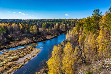 Fototapeta na wymiar Autumn landscape with river, trees, grass and blue sky
