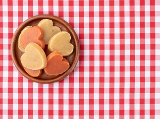 Sweet potato candy, typical brazilian june festival food over plaid fabric with copy space