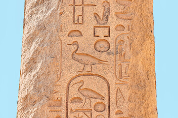 An obelisk with Egyptian carved hieroglyphs in Luxor. History and travel concept
