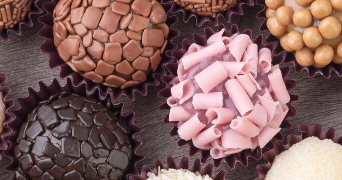 Typical brazilian brigadeiros, various flavors over wooden table