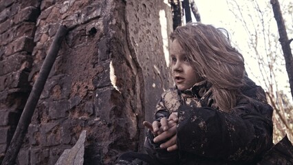 girl praying. Children without a home, apocalypse, war