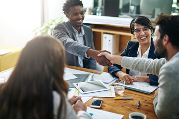 Its great to have you on board. Cropped shot of two businessmen shaking hands during a meeting.